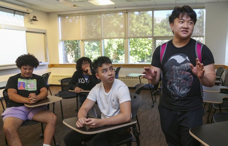Kevin Tran, 16, right, speaks about the Bridge to Calculus summer program at Northeastern University in Boston on Tuesday, Aug. 1, 2023. Like a lot of high school students, Tran loves superheroes, though perhaps for different reasons than his classmates. “They’re all insanely smart. In their regular jobs they’re engineers, they’re scientists,” he says. “And you can’t do any of those things without math.” (AP Photo/Reba Saldanha)