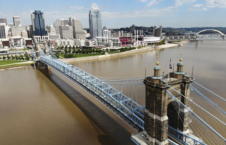 The Cincinnati skyline and John A. Roebling Suspension Bridge is seen from the banks of the Ohio River, Tuesday, Sept. 18, 2018, in Covington, Ky. (AP Photo/John Minchillo)