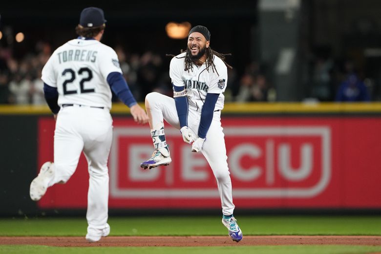 Seattle Mariners’ J.P. Crawford, right, celebrates his game-winning, two-run double with Luis Torrens (22) against the Texas Rangers during the ninth inning of a baseball game Thursday, Sept. 28, 2023, in Seattle. (Lindsey Wasson / The Associated Press)