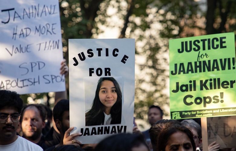 People hold signs as they march Saturday, Sept. 16, 2023, from Denny Park to the site in which Jaahnavi Kandula was struck and killed in Seattle. This rally and others this past weekend in Seattle are in protest against insensitivity towards Jaahnavi Kandulan’s death by a Seattle Police Department Officer.