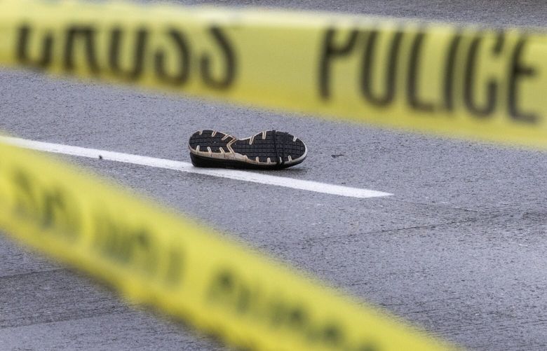 The shoe of a fatally struck pedestrian is seen in the middle of southbound Martin Luther King Jr. Way S., Thursday morning, Sept. 28, 2023 in Seattle. This is one of two fatal vehicle/pedestrian accidents during the morning commute.