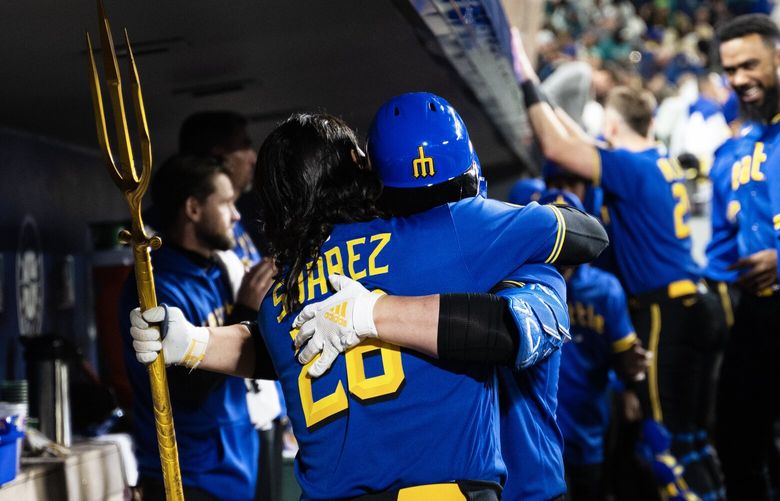 After hitting a homer mariners first baseman hugs third base Eugenio Suárez Friday, Sept. 29, 2023, as the Seattle Mariners take on the Texas Rangers at T-Mobile Park in Seattle.