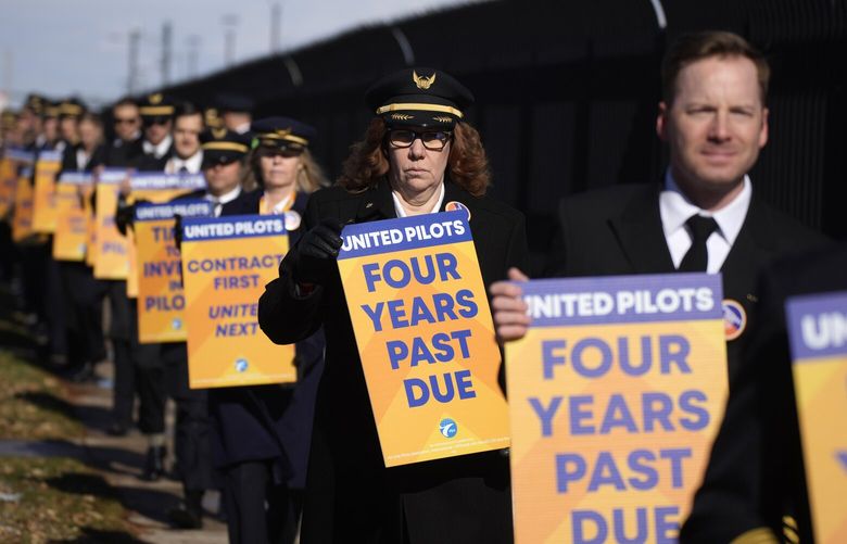 FILE – United Airlines pilots as well as other supporters walk an informational picket line to signify the pilot union’s commitment to attain an industry-leading contract on Tuesday, Nov. 15, 2022, outside the United Airlines flight training center in east Denver. Pilots at United Airlines have ratified a new four-year contract. Their union said Friday, Sept. 29, 2023, the deal will raise pay and improve benefits, and is worth more than $10 billion. (AP Photo/David Zalubowski, File) NYWS305 NYWS305