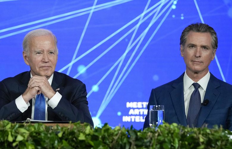 FILE – President Joe Biden and California Gov. Gavin Newsom wait for reporters to leave the room during a discussion on managing the risks of Artificial Intelligence during an event in San Francisco, June 20, 2023. (AP Photo/Susan Walsh, File) WX476 WX476