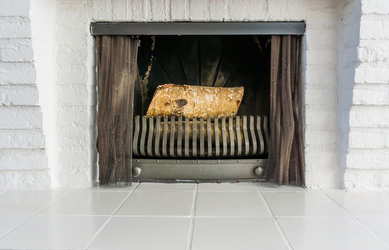 When painting a fireplace, look for high-temperature paint made to withstand the heat. It dries at room temperature, so it sticks well to bricks, tile and many other surfaces. (Getty Images)