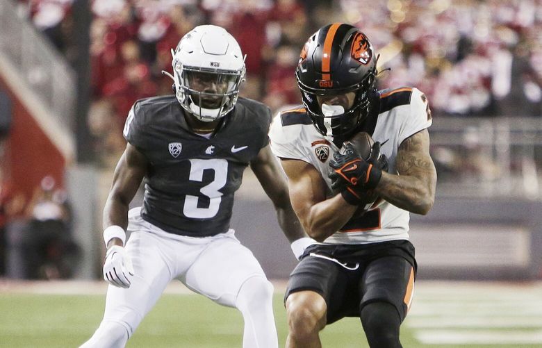 Oregon State wide receiver Anthony Gould, right, secures a pass next to Washington State defensive back Cam Lampkin (3) during the second half of an NCAA college football game, Saturday, Sept. 23, 2023, in Pullman, Wash. Washington State won 38-35. (AP Photo/Young Kwak) WAYK120 WAYK120