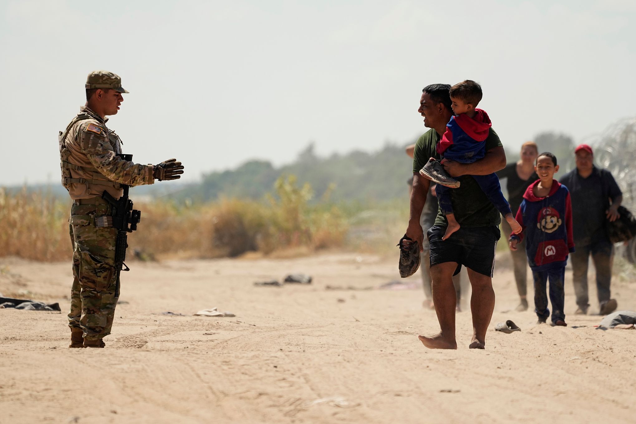 U.S. Customs agent David Gonzalez helps a traveler from Mexico use