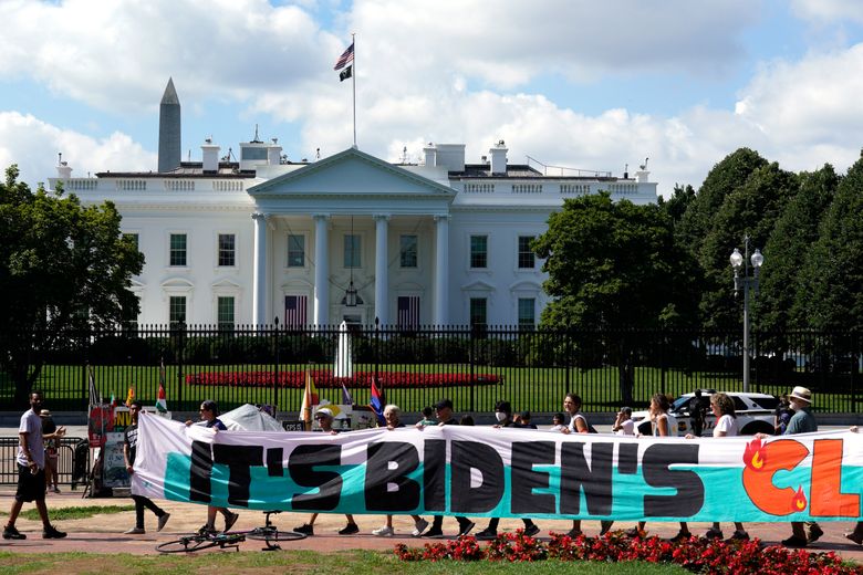 FILE – Climate activists rally in front of the White House at Lafayette Square to demand that President Joe Biden declare a climate emergency and move the country rapidly away from fossil fuels, July 4, 2023, in Washington. After being thwarted by Congress, Biden will use his executive authority to create a New Deal-style American Climate Corps that will serve as a major green jobs training program. (AP Photo/Yuri Gripas, File)