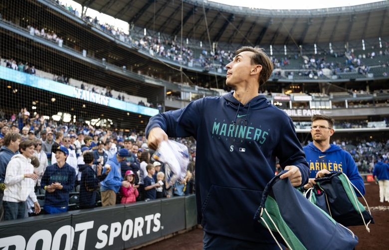 Mariners pitcher George Kirby throws merchandise to fans Sunday, Oct. 1, 2023, after the Seattle Mariners beat the Texas Rangers at T-Mobile Park in Seattle for the final game of the season. The Mariners won 1-0.