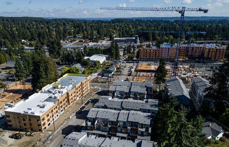Massive apartment buildings at various stages of construction are seen from the air in Shoreline, Sunday Oct. 1, 2023. Light-rail tracks approaching the yet-to-open South Shoreline station are seen in the background. Area growth projections yield firm numbers for future housing goals.