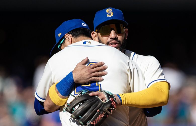 Mariners shortstop José Caballero hugs second baseman Josh Rojas Sunday, Oct. 1, 2023, after the Seattle Mariners beat the Texas Rangers at T-Mobile Park in Seattle for the final game of the season. The Mariners won 1-0.