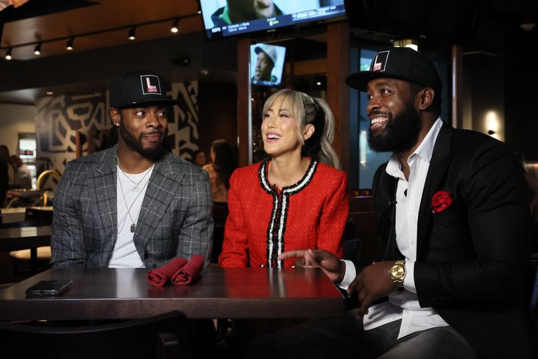 Richard Sherman, left, Leilani Wong and Kam Chancellor will open their “elevated” sports bar Legion on Tuesday in downtown Bellevue. (Kevin Clark / The Seattle Times)