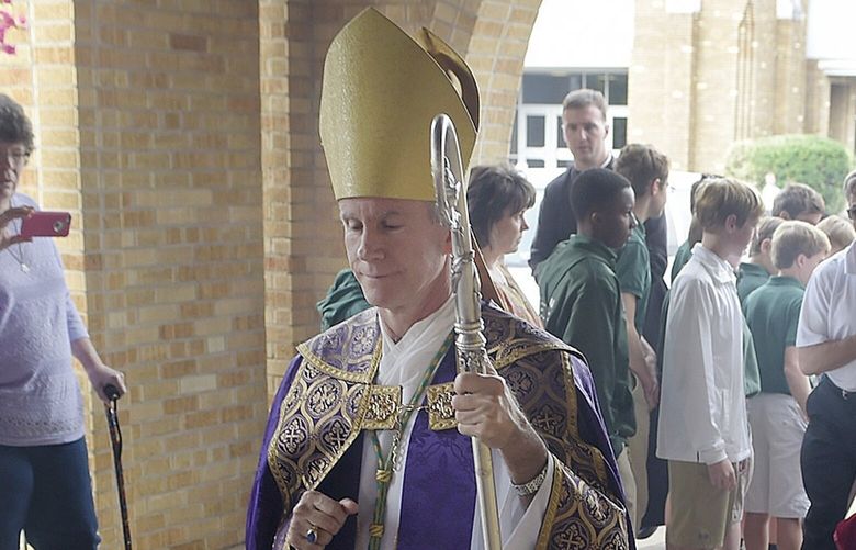 FILE – Bishop Joseph Strickland walks in front of a reliquary bearing the bones of Saint Maria Goretti, dubbed “The Little Saint of Great Mercy,” as it is wheeled past parish members and into the sanctuary at Cathedral of the Immaculate Conception on Monday, Nov. 2, 2015, All Souls’ Day, in Tyler, Texas. Strickland, critiquing the upcoming October 2023 synod at the Vatican on social media said, “It is a travesty that these things are even proposed for discussion.” “Regrettably, it may be that some will label as schismatics those who disagree with the changes being proposed,” he added in a public letter in August 2023. (Andrew D. Brosig/Tyler Morning Telegraph via AP, File) TXTYL684 TXTYL684