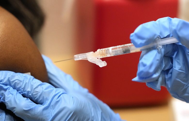 A pharmacist administers a Moderna Spikevax COVID-19 vaccine at a drug store, Wednesday, Sept. 20, 2023, in Cypress, Texas. Fall 2023 vaccination season is in full swing, with health officials in the U.S. urging both an updated COVID-19 shot and flu vaccine for most everyone. New this year are vaccines for older adults and women in late pregnancy to guard against another virus named RSV. (Melissa Phillip/Houston Chronicle via AP) TXHOU733 TXHOU733