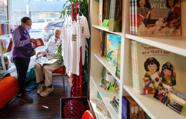 Bernadette Janet, left, and Adrian Dee browse books in the window of Mam’s Books during “soft grand opening” Friday afternoon in Seattle, Washington on September 29, 2023. 225076