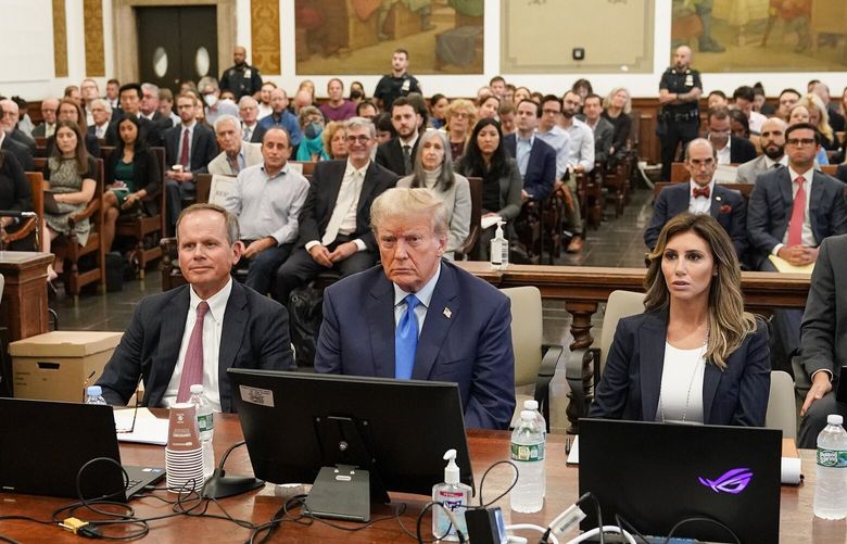 Former President Donald Trump, center, sits in the courtroom at New York Supreme Court, Monday, Oct. 2, 2023, in New York. Trump is making a rare, voluntary trip to court in New York for the start of a civil trial in a lawsuit that already has resulted in a judge ruling that he committed fraud in his business dealings. (AP Photo/Seth Wenig) NYJJ216 NYJJ216