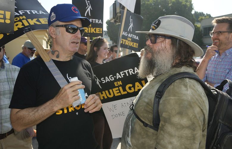 Actors Bob Odenkirk, left, and Jack Black, right, join demonstrators outside the Paramount Pictures Studio in Los Angeles, Tuesday, Sept. 26, 2023. (AP Photo/Damian Dovarganes) CADD224 CADD224