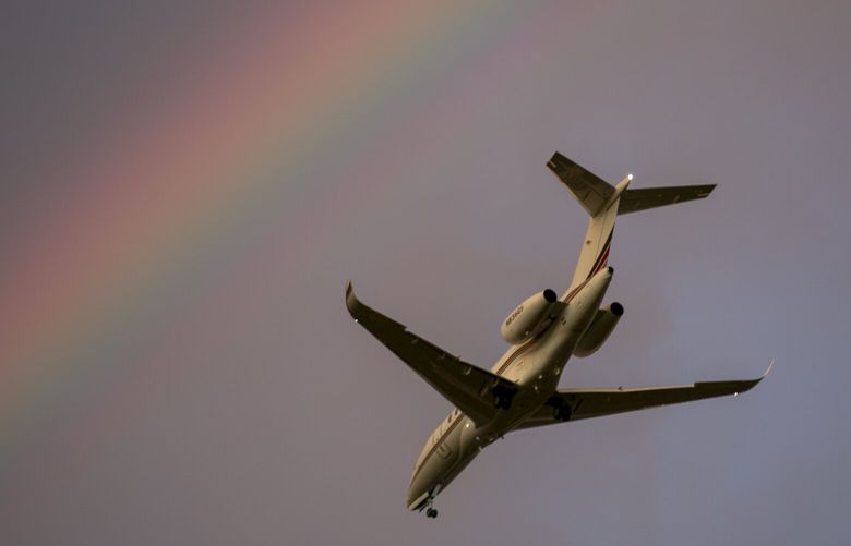 A plane that took off from Teterboro Airport passes by a rainbow in the sky over Rutherford, New Jersey, on Monday, September 18, 2023. (AP Photo/Ted Shaffrey) RPTS107 RPTS107