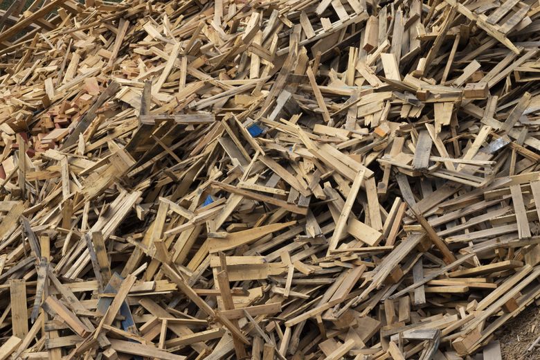 Usable lumber is stacked up at DTG Recycle in Snohomish, which grinds it into hog fuel and landscaping mulch. In July, 36% of construction and demolition waste processed at the facility was recycled. The rest was landfilled. (Ellen M. Banner / The Seattle Times)