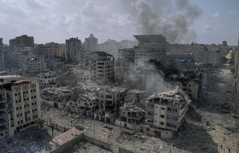 A view of the rubble of buildings hit by an Israeli airstrike, in Gaza City, Tuesday, Oct. 10, 2023. Israel has launched intense airstrikes in Gaza after the territory’s militant rulers carried out an unprecedented attack on Israel Saturday, killing over 900 people and taking captives. Hundreds of Palestinians have been killed in the airstrikes. (AP Photo/Hatem Moussa) XOB113 XOB113