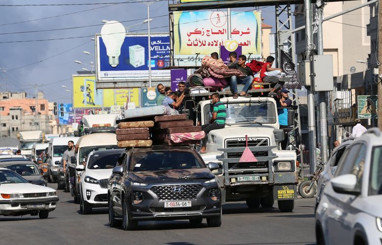 Vehicles laden with people and belongings navigate traffic on Salah El Deen Road, near Khan Younis in the southern half of the Gaza Strip, amid mass evacuations in the northern part on Friday, Oct. 13, 2023. Panic and chaos gripped the northern Gaza Strip Friday as thousands of people fled south along two main roads after the Israeli military ordered a mass evacuation of half of the besieged coastal strip.   (Samar Abu Elouf/The New York Times) (SAMAR ABU ELOUF / NYT)