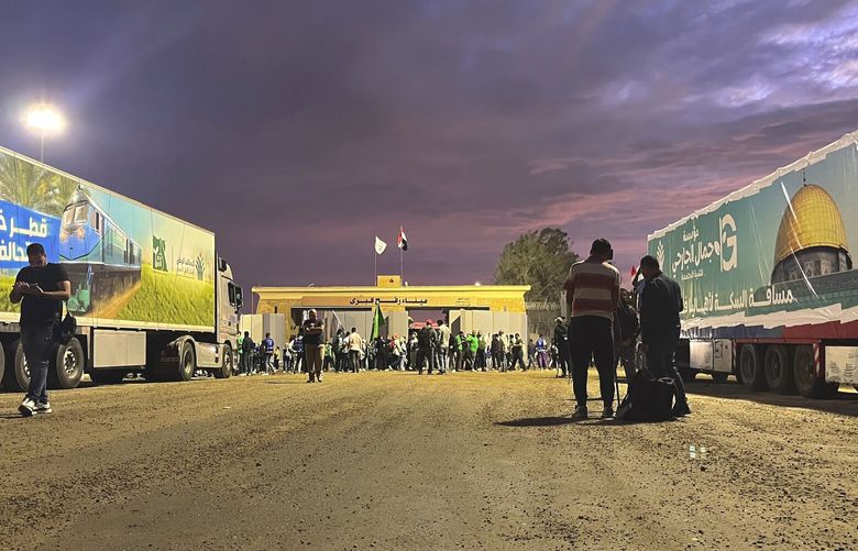 Humanitarian aid convoy for the Gaza Strip is parked at the Rafah crossing port, Egypt, Tuesday, Oct. 17, 2023. Hundreds of Palestinians in the Gaza Strip have fled their homes ahead of an expected Israeli ground invasion aimed at destroying Hamas after its fighters rampaged through southern Israel. (AP Photo/Omar Aziz) AMR101 AMR101