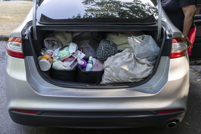 The trunk of Chrystal Audet’s car has become the closet. (Ruth Fremson / The New York Times) 