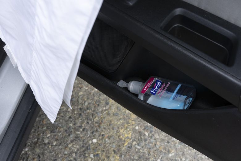 Hand sanitizer inside the door of Chrystal Audet’s car. (Ruth Fremson / The New York Times)