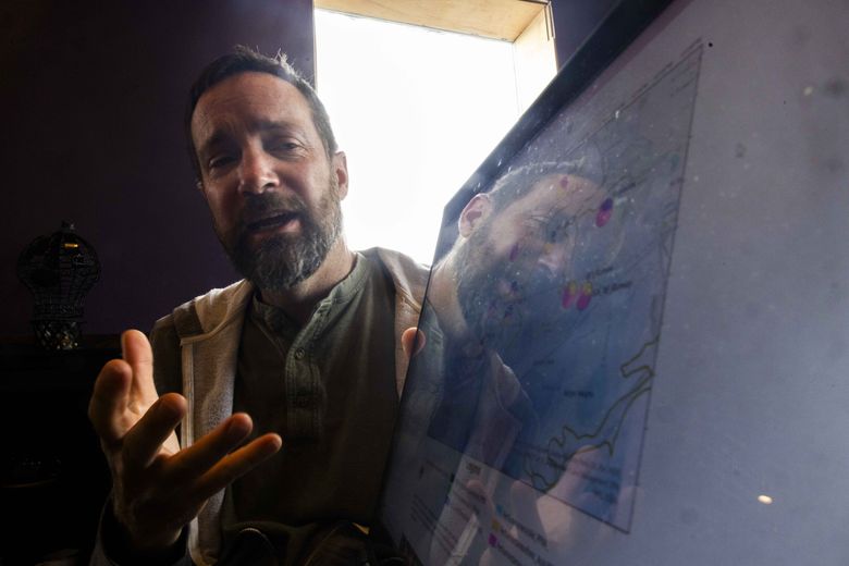 Hydrogeologist Chad Pritchard explains the flow of groundwater near the Fairchild Air Force Base and Spokane International Airport. (Daniel Kim / The Seattle Times)