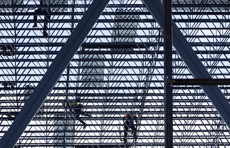 Iron workers work on the roof of a two-story core and shell storage facility located at 44 South Nevada St. in Seattle Thursday, October 19, 2023. 
When completed, the building will have 656,035 square feet of warehouse space, 34,606 square feet of potential office space and 117,770 square feet of fleet vehicle storage.  The ground level will also have an open parking area with 394 stalls.  The general contractor is Lease Crutcher Lewis.   The building is expected to be completed in 2024.   225269