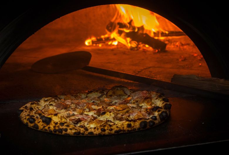 Pizza with golden chanterelle mushrooms, prosciutto di Parma, black truffle pecorino and cherry tomatoes at  Bar del Corso on Seattle&#8217;s Beacon Hill. (Ellen M. Banner / The Seattle Times)