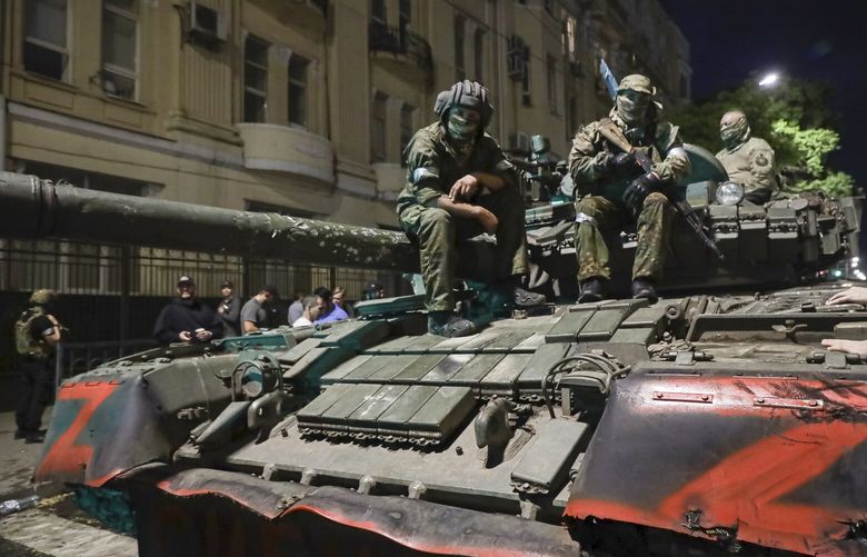 Membes of the Wagner Group military company sit atop of a tank on a street in Rostov-on-Don, Russia, Saturday, June 24, 2023, prior to leaving an area at the headquarters of the Southern Military District. Kremlin spokesman Dmitry Peskov said that Yevgeny Prigozhin’s troops who joined him in the uprising will not face prosecution and those who did not will be offered contracts by the Defense Ministry. After the deal was reached Saturday, Prigozhin ordered his troops to halt their march on Moscow and retreat to field camps in Ukraine, where they have been fighting alongside Russian troops. (AP Photo) XAZ166 XAZ166