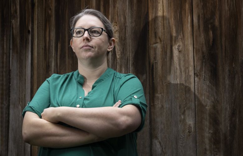 Pamela Hayter, a former Amazon employee, stands in the backyard of her Kirkland home Monday, October 23, 2023.  Hayter was one of the most vocal critics of the company’s return to office mandate. She started a Slack channel that eventually led to a petition and the walk-out in May. Now, she’s sued Amazon for wrongful termination after being placed on a performance improvement plan that she says is directly related to her remote work advocacy campaign. 225267