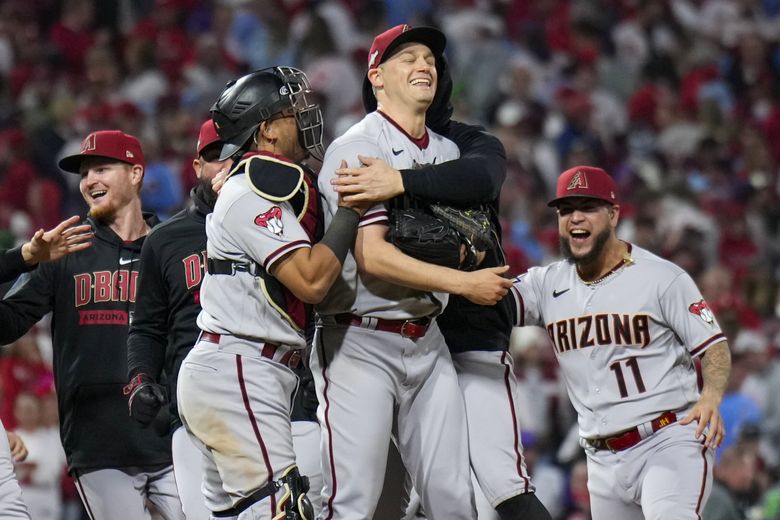 Seattle Mariners relief pitcher Paul Sewald stands between