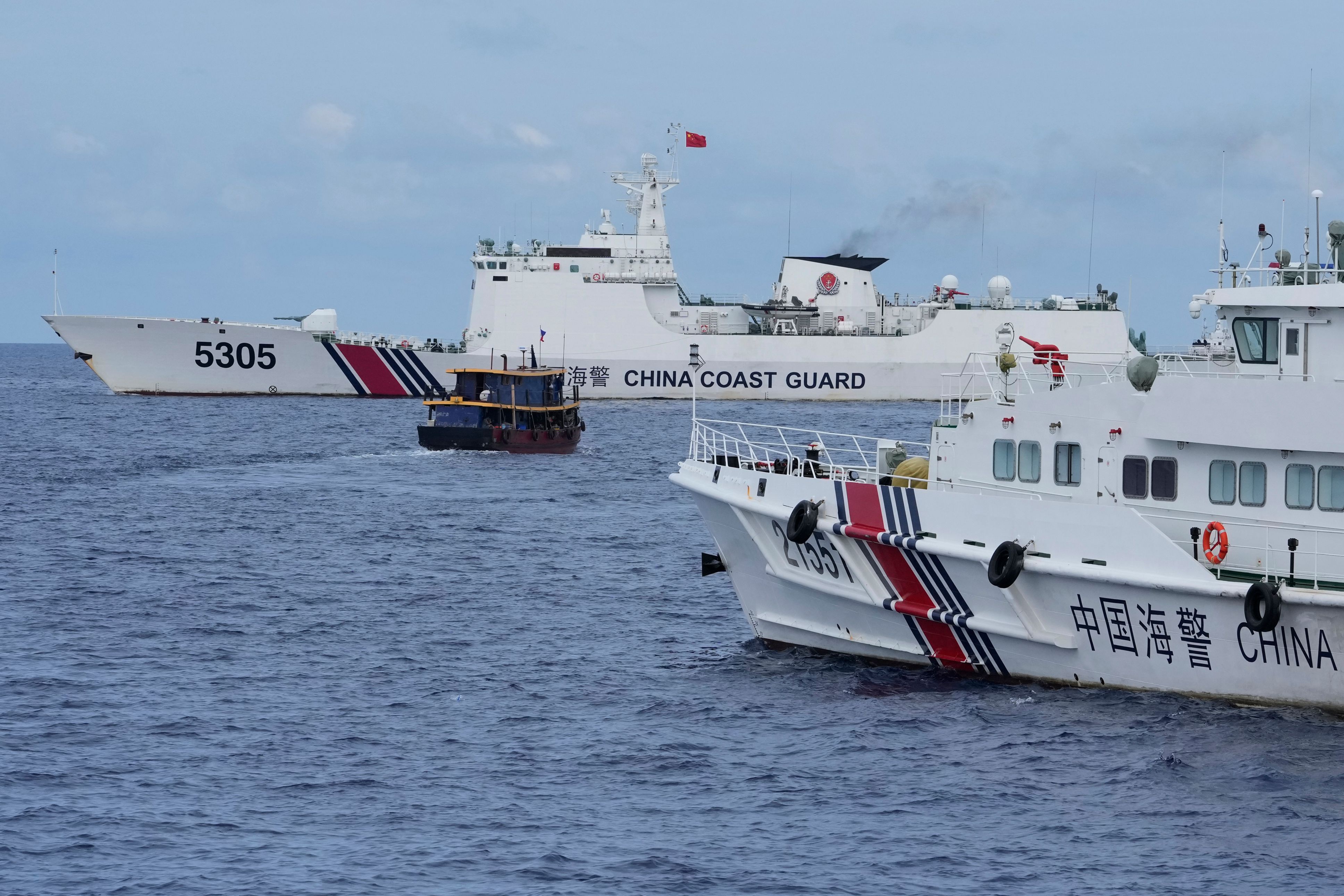 Philippine boats breach a Chinese coast guard blockade in a