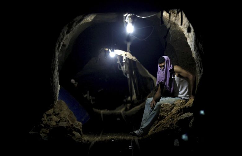 FILE – A Palestinian worker rests inside a smuggling tunnel in Rafah, on the border between Egypt and the southern Gaza Strip Sept. 30, 2013. An extensive labyrinth of tunnels built by Hamas stretches across the dense neighborhoods of the Gaza Strip, hiding militants, their missile arsenal and the over 200 hostages they now hold after an unprecedented Oct. 7, 2023, attack on Israel. (AP Photo/Hatem Moussa, File) XJG503 XJG503