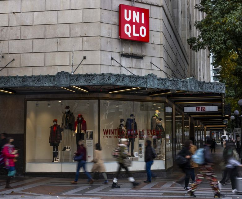 Shoppers and visitors walk past Uniqlo, in the old Bon Marché/Macy&#8217;s building at Fourth and Pine. (Daniel Kim / The Seattle Times)