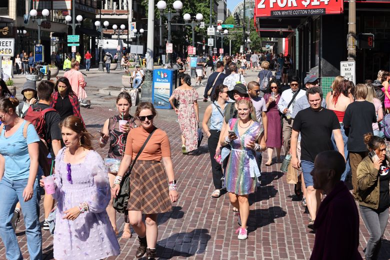 It&#8217;s a busy scene on First Avenue in front of Pike Place Market on a warm summer day. (Karen Ducey / The Seattle Times)
