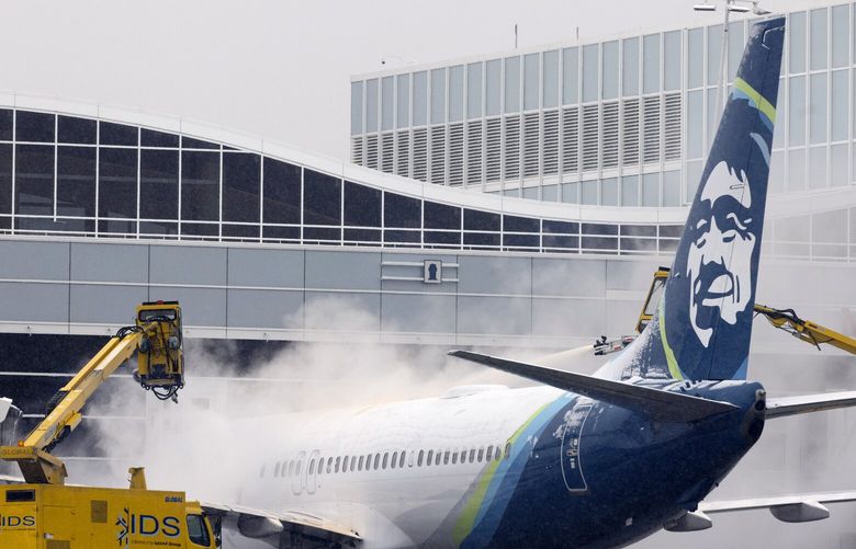 An Alaska Airlines plane is de-iced early Tuesday morning, Nov. 29, 2022. More than 100 Alaska Airlines flights were canceled due to the weather.  222318