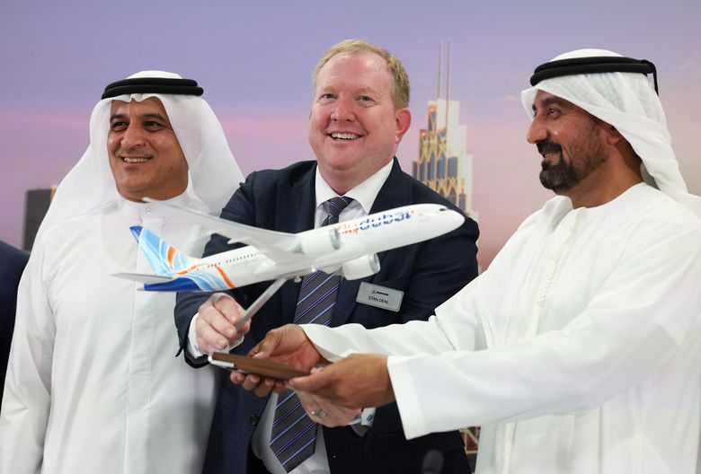 At the Dubai Air Show Monday, Stan Deal, CEO of Boeing Commercial Airplanes stands with Ghaith al-Ghaith, CEO of FlyDubai, left, and Sheikh Ahmed bin Saeed Al Maktoum, chair of Emirates Airlines, at a news conference. Emirates placed a huge order for 777X and 787 airplanes while FlyDubai ordered 787s. (Christopher Pike / Bloomberg)