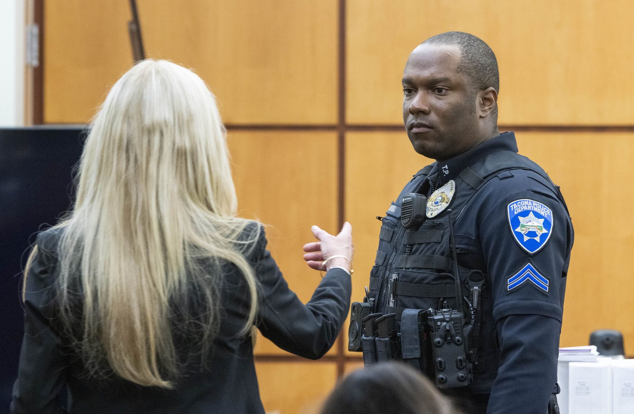 Tacoma police Officer Masyih Ford stands so he can show Anne Bremner, attorney for Timothy Rankine, and the jury the gear he carries as he testifies in Pierce County Superior Court in Tacoma on Wednesday. 