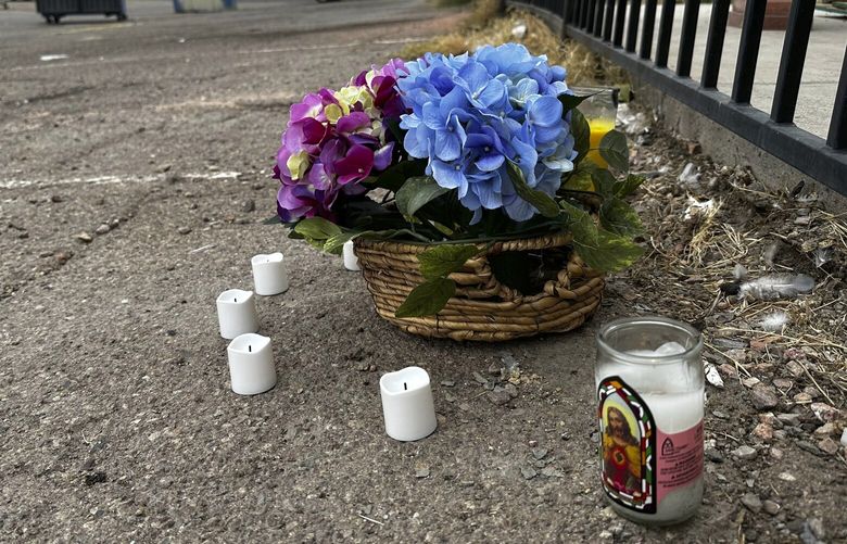 A makeshift memorial for a high school student lines a fence along an alleyway near Rancho High School in eastern Las Vegas on Wednesday, Nov. 15, 2023. Authorities arrested eight teens Tuesday in connection with the beating of Jonathan Lewis Jr., who died a week after a prearranged fight over a pair of headphones and a vape pen. (AP Photo/Rio Yamat) NVRY101 NVRY101