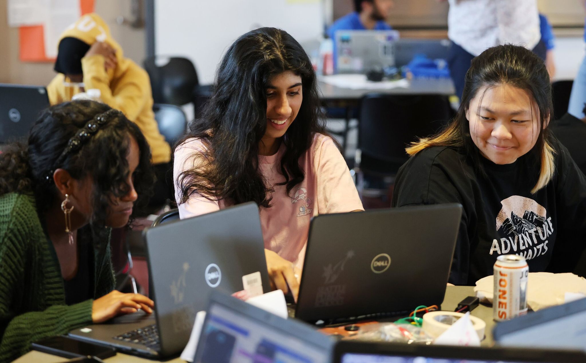 High school students Nariah McGee, left, Sahar Abid and Manyi Zhao discuss their project assignment during Amazon’s Future Engineer summer program at Seattle World School on July 27.