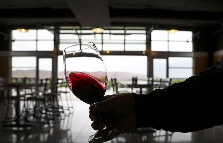 Winemaker Charlie Hoppes shows the color of his 2016 Quintessence Cabernet Sauvignon at his Fidelitas tasting room in the Red Mountain AVA, Tuesday, Sept. 17, 2019 near Benton City. Hoppes says his last wine made with non-Red Mountain fruit was a 2014 Fidelitas Champoux. “We’re all in on Red Mountain. I believe in the AVA. We pushed all our chips right to the center,” said Hoppes. 210960
