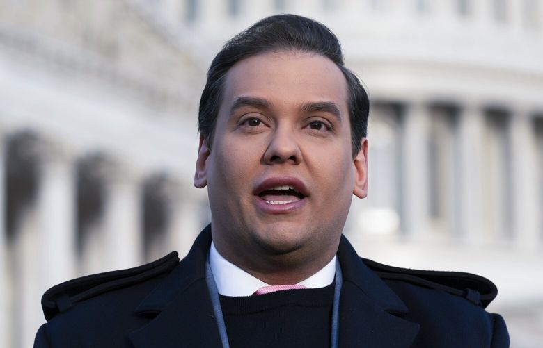 Rep. George Santos, R-N.Y., faces reporters at the Capitol in Washington, early Thursday, Nov. 30, 2023. After a scathing report by the House Ethics Committee citing egregious violations, Santos could be expelled from Congress this week. (AP Photo/J. Scott Applewhite) DCSA105 DCSA105