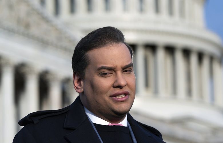 Rep. George Santos, R-N.Y., faces reporters at the Capitol in Washington, early Thursday, Nov. 30, 2023. After a scathing report by the House Ethics Committee citing egregious violations, Santos could be expelled from Congress this week. (AP Photo/J. Scott Applewhite) DCSA119 DCSA119