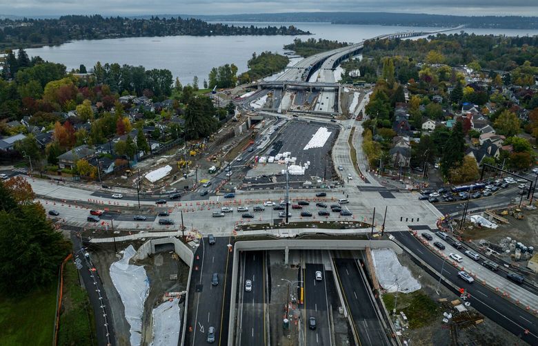 The massive 520 lid project at Montlake takes shape, seen from the air looking east across Lake Washington, Sunday, Oct. 22, 2023 in Seattle. At nearby University of Washington, Kaylie Mattingly, a civil engineering student, has already found job offers from contracting firms with graduation still nine months away.