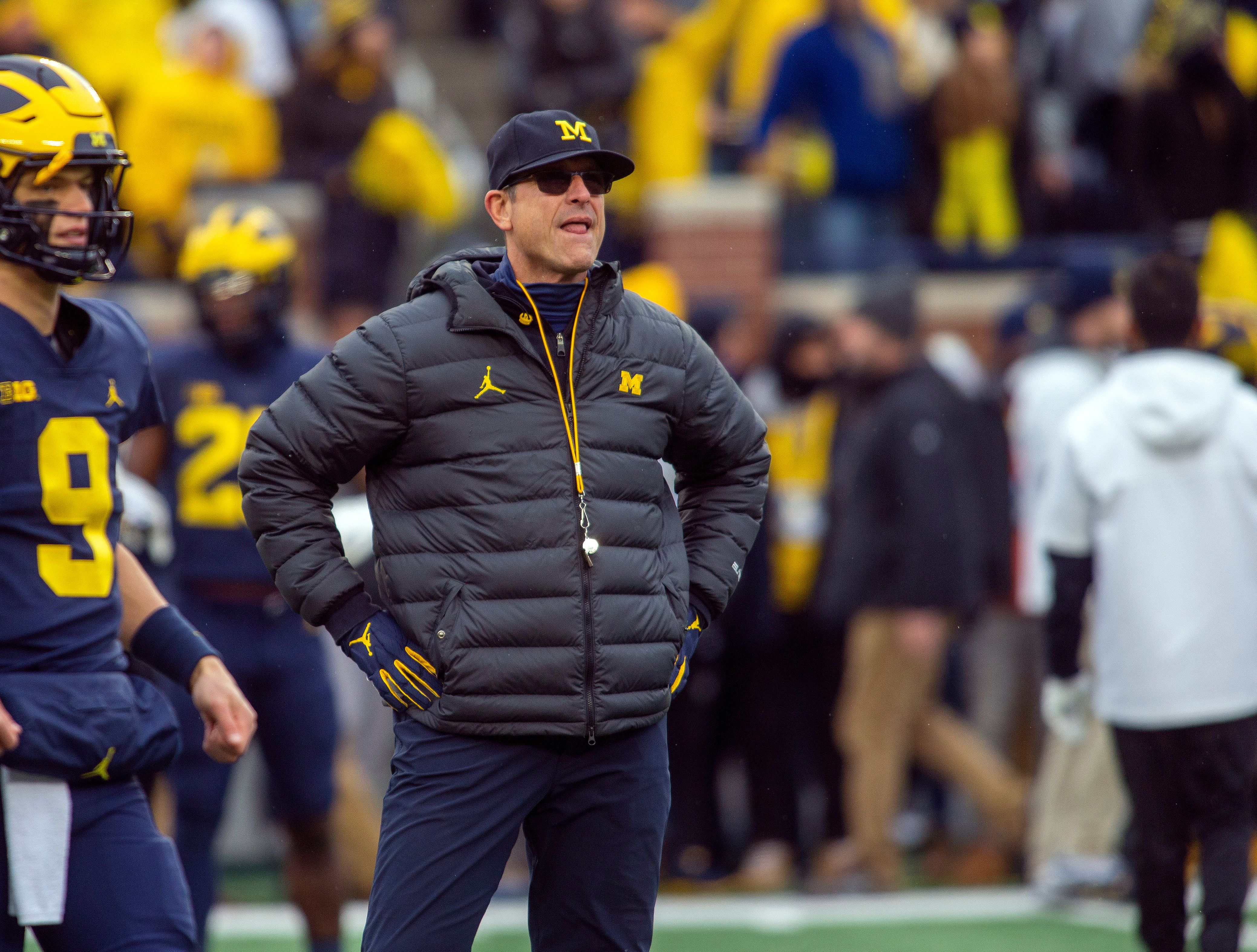 Michigan's Jim Harbaugh says he would take less salary if it meant