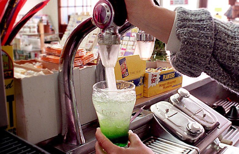 KRT TRAVEL STORY SLUGGED: SODA KRT PHOTOGRAPH BY JIM JANICKE/KANSAS CITY STAR (KRT24-  February 22) The original carbonated water taps still function on the soda fountain in Glasco, Kansas. Proprietor Judy Wyatt mixes a green dragon. (KC) PL KD AP 1999 (Horiz) (Additional photos available on KRT Direct, KRT/PressLink or upon request)