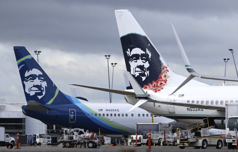 FILE – In this Monday, April 4, 2016, file photo, Alaska Airlines planes with the company’s new livery and tail logo, left, and the old livery used to promote service to Hawaii, right, are shown parked at Seattle-Tacoma International Airport in Seattle. Alaska Airlines slipped past rival Hawaiian Airlines to post the best on-time rating for U.S. carriers in July 2016, the Department of Transportation said Tuesday, Sept. 13. (AP Photo/Ted S. Warren, File)